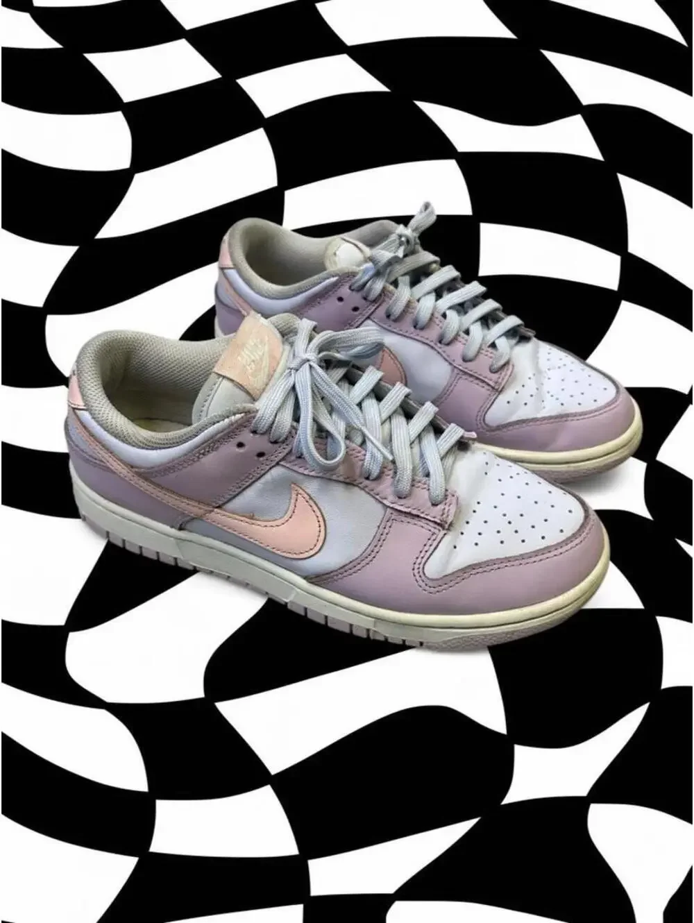 Nike Dunk Low Easter sneakers in pink, white, and peach with a Nike swoosh